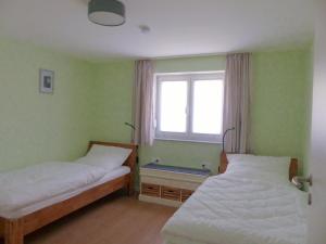 Кровать или кровати в номере Ferienwohnungen Flora