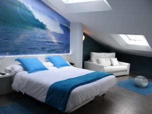 a bedroom with a large bed with a painting on the wall at Bekale in Ea