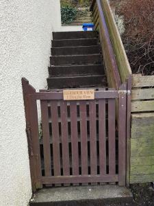 a set of stairs with a sign that reads unlawful entry to a house at Harbour View in Portree