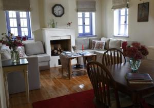a living room with a couch and a table at Papigo Stonehouse in Papingo