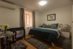 a bedroom with a bed and a desk and a window at Villa Lucija Vodice in Vodice
