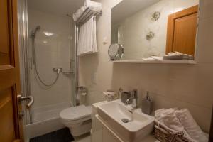 a bathroom with a sink and a toilet and a shower at Villa Lucija Vodice in Vodice +26 photos