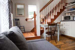 a living room with a couch and a table with a microwave at Salt Shaker Deli & Inn in Lunenburg +20 photos