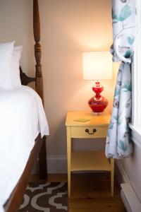 a bedroom with a bed and a lamp at Salt Shaker Deli & Inn in Lunenburg