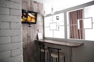 a bar in a room with a tv on a wall at Rent of Apartments in Kharkiv in Kharkiv