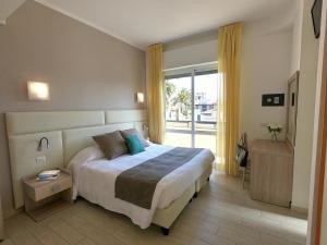 Säng eller sängar i ett rum på Hotel Residence La Palma