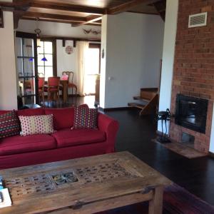 a living room with a red couch and a fireplace at Selimiye Houses in Selimiye