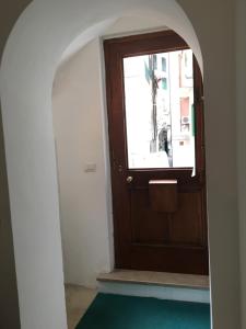 an archway leading to a wooden door with a window at Romantic getaway in the heart of Amalfi in Amalfi