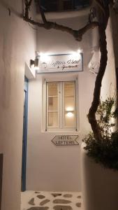 a building with a window and a sign on the wall at Lefteris in Mikonos +62 photos