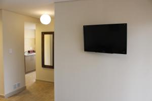 a flat screen tv hanging on a wall at Temporarios B & B in San Salvador de Jujuy