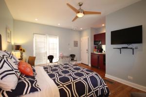 a bedroom with a bed and a flat screen tv at Magnolia Studios in Chicago