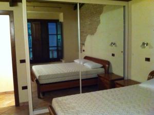 a bedroom with two beds and a mirror at Residence LA FORTUNA in Fano