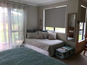 
a bedroom with a bed and a desk at Abel Tasman Sands BnB in Marahau
