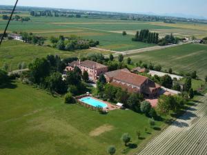 an aerial view of a house in a field with a pool at Bordeghina B&B In Farmhouse in Pontecchio Polesine