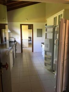 a kitchen with a refrigerator and a tile floor at Carlos Franco Country Golf in Arroyos y Esteros