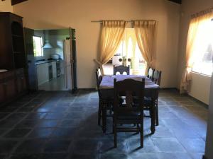 a kitchen and dining room with a table and chairs at Carlos Franco Country Golf in Arroyos y Esteros