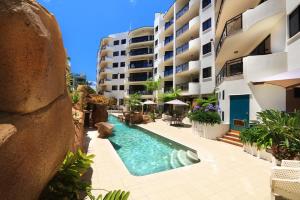 a swimming pool in the middle of a building at Caribbean Resort in Mooloolaba +35 photos