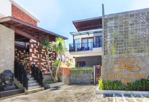 a building with a sign on the side of it at Mokko Suite Villas Umalas Bali in Seminyak