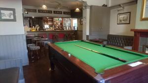 a pool table in a pub with a bar at The Queens in St Bees
