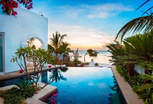 a swimming pool with a view of the ocean at The Aiyana Resort & Spa in Verani