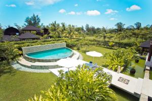 an aerial view of a swimming pool with umbrellas at Kudat Riviera Exclusive Beach Villas in Kudat