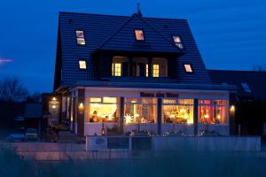 a store front of a house at night at Haus am Meer in Scharbeutz
