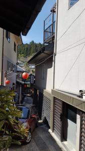 a car parked in a parking lot next to a building at Ryokan Maruya in Yufu