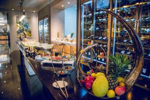 a bar with baskets of fruit on a counter at Cachet Boutique Kunming Artime in Kunming