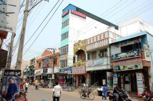 a busy city street with people walking and buildings at Jayaram Residency Srikalahasti in Srikalahasti