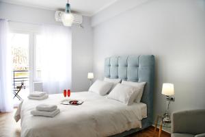 a bedroom with a large bed with a blue headboard at Hellenic Hospitality House in Athens