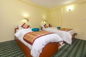 Llit o llits en una habitació de Hotel Noble Inn花椒客栈