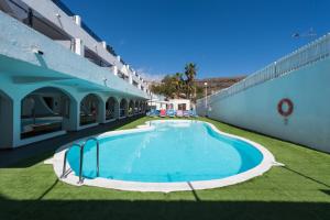 a large swimming pool in the middle of a building at eó Corona Cedral in Puerto Rico de Gran Canaria