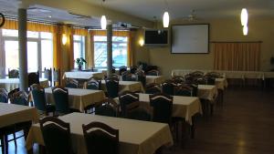 a conference room with tables and chairs and a screen at Hotel YORK in Pilsen