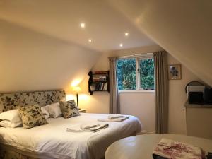 a bedroom with two beds and a window at The Apple Loft in Westleton