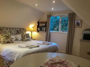 a small room with two beds and a window at The Apple Loft in Westleton