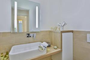 a bathroom with a white sink and a mirror at MY CASA FRANCE 82 TP - Terrace AC & Parking in Nice