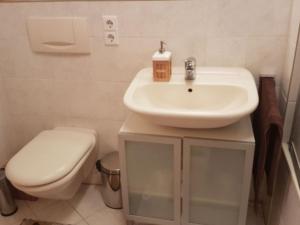 a bathroom with a white sink and a toilet at Ferienwohnung Christa in Sankt Märgen