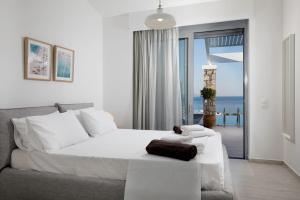 a bedroom with a bed and a view of the ocean at Villa Serene with swimming pool in Lindos in Líndos