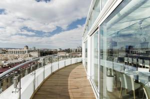 a balcony of a building with a view of a city at Nobil Luxury Boutique Hotel in Chişinău