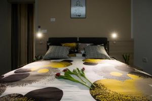 a bedroom with a bed with flowers on it at Apartma Grže in Postojna