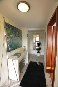 a hallway with a table and a painting on the wall at Ferienwohnung Brohltal-Aue in Burgbrohl