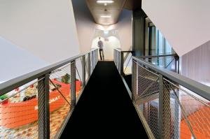 a staircase in a building with a person walking down it at Stayokay Hostel Rotterdam in Rotterdam