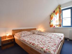 a bedroom with a bed and a window at Stylish Apartment in Ostseebad Boltenhagen with Balcony in Boltenhagen