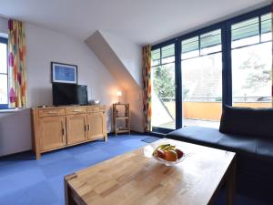 a living room with a couch and a table at Stylish Apartment in Ostseebad Boltenhagen with Balcony in Boltenhagen