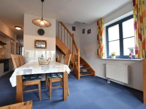 a kitchen and dining room with a table and chairs at Stylish Apartment in Ostseebad Boltenhagen with Balcony in Boltenhagen