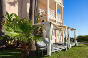 a house with a porch with a swing at Hipotels Playa La Barrosa - Adults Only in Chiclana de la Frontera