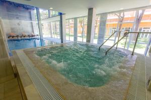 a hot tub in the middle of a building at Hipotels Playa La Barrosa - Adults Only in Chiclana de la Frontera