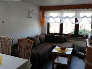 a living room with a couch and a table at Holiday Home in Altenfeld with Private Pool in Altenfeld