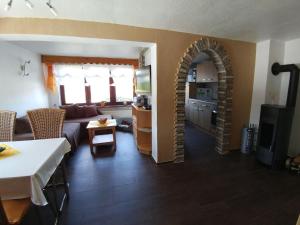 a living room with an archway and a kitchen at Holiday Home in Altenfeld with Private Pool in Altenfeld