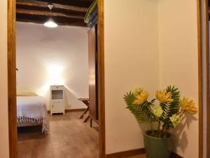 a room with a bed and a vase with flowers at Scenic Home in Berbiguières in Saint-Germain-de-Belvès +21 photos